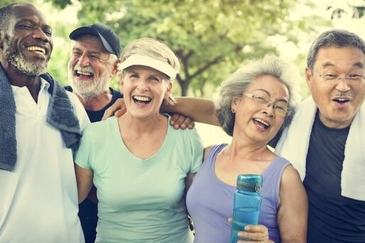 Group of senior friends relaxing after taking a fitness class together.