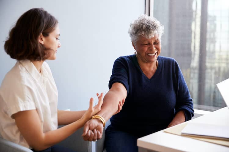 Senior woman receiving a vaccine.